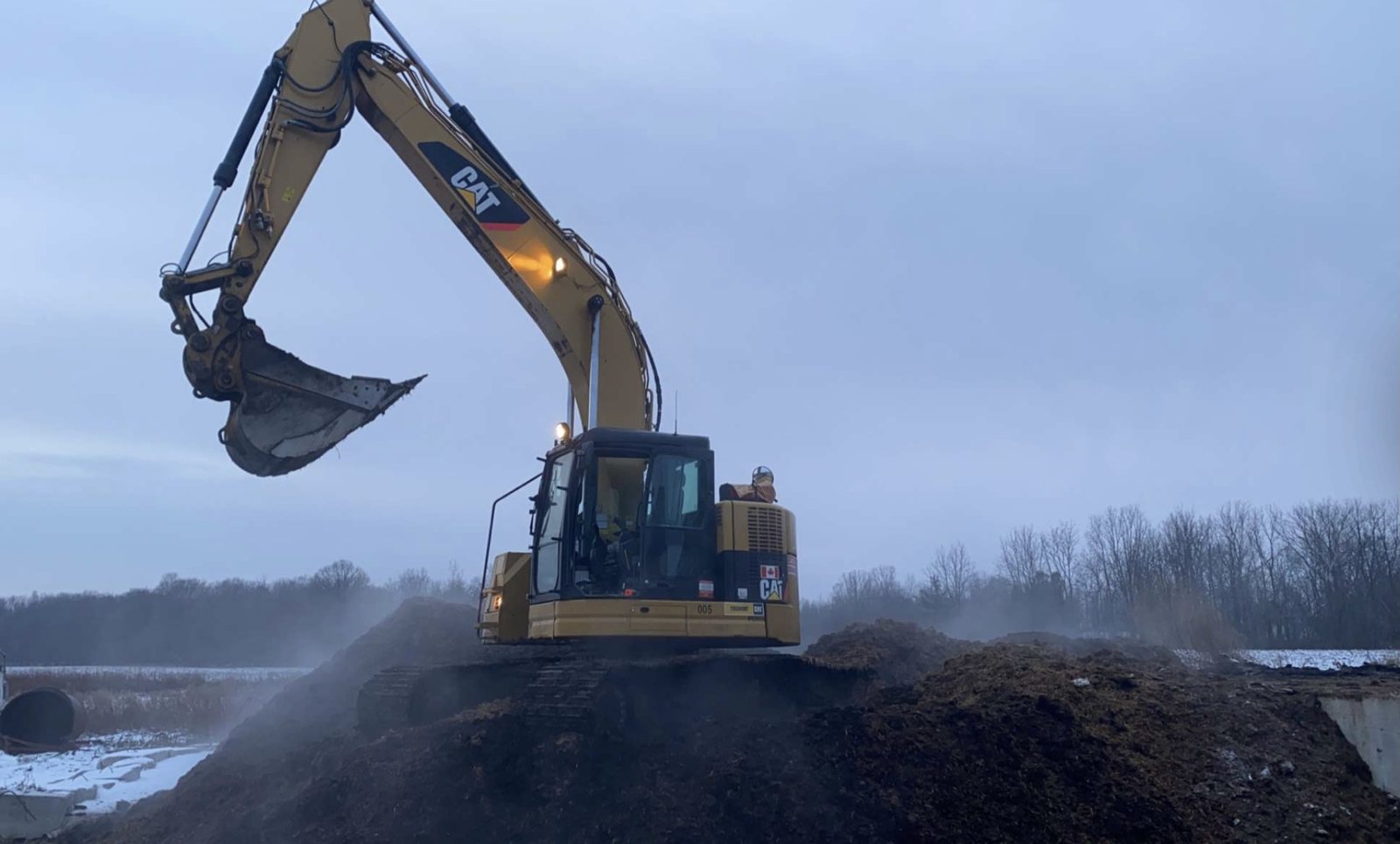 Excavator moving soil during an excavation project
