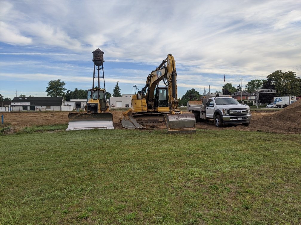 Excavator and truck set up at a rural worksite
