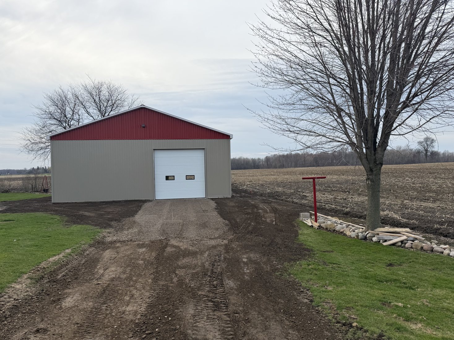 Finished driveway and grading work leading to a rural building